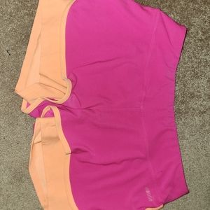 Pink shorts with orange compression shorts under